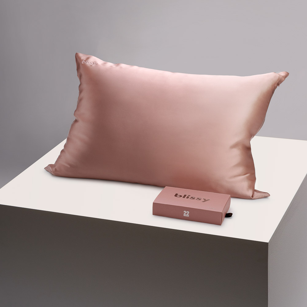 Blissy rose gold pillowcase on a table